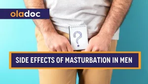 A man holding a paper with a question mark on it over his private parts.