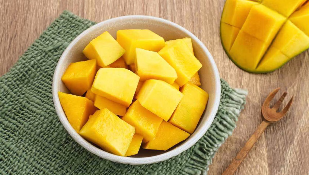 A single serving of freshly cut mango pieces in a bowl