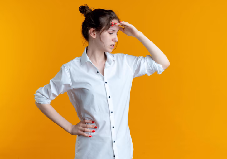 a women putting a hand on her forehead facing deficiency of calcium