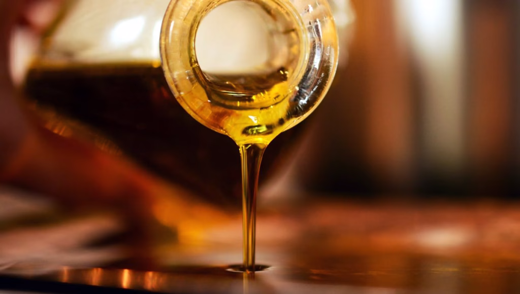 Pouring a bottle of jojoba oil